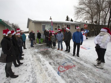 Radio station C95, the Kinsmen Club of Saskatoon and other sponsors surprised Janelle Bruneau and her sons, Tyler and Trey, with a Christmas Wish, December 14, 2015.  They were surprised with toys, groceries, gifts and even a car — courtesy of Precision Auto Body. People wait to greet the family at their home.