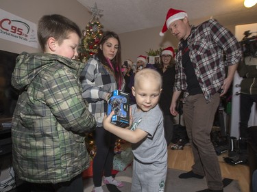 Radio station C95, the Kinsmen Club of Saskatoon and other sponsors surprised Janelle Bruneau and her sons, Tyler and Trey, with a Christmas Wish, December 14, 2015.  They were surprised with toys, groceries, gifts and even a car — courtesy of Precision Auto Body.