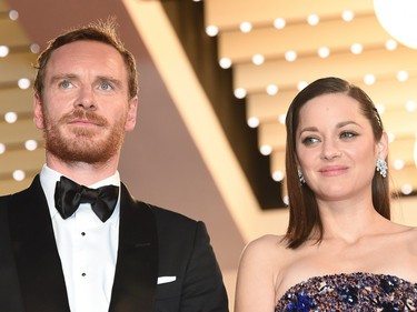 German-Irish actor Michael Fassbender (L) and French actor Marion Cotillard pose before leaving the Festival Palace after the screening of "Macbeth" at the 68th Cannes Film Festival in Cannes, France, May 23, 2015.