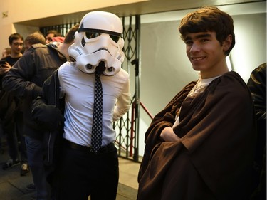 People wearing Star Wars character costumes wait at the Grand Rex cinema in Paris for the French released day of Star Wars: The Force Awakens on Dec. 16, 2015.