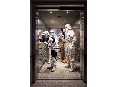 Members of the Star Wars "Star Wars Fans Nuernberg" fan club dressed as Star Wars characters stand in an elevator at a cinema in Nuremberg, southern Germany, on December 16, 2015.  Star Wars: The Force Awakens had its German Premiere on December 16, 2015.