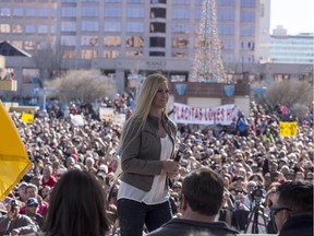 Holly Holm addresses a crowd of fans after a parade for UFC women's bantamweight champion in her native Albuquerque, N.M., Sunday, Dec. 6, 2015. Holm captured the belt from the previously undefeated Ronda Rousey on Nov. 14, in Australia.
