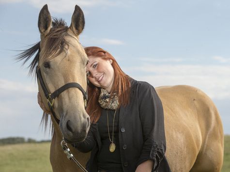 Erin Vasson, a grief councillor with WCVM, poses for a photograph with her horse Gunner at her farm on Tuesday, August 18th, 2015.