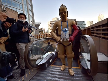 A fan dressed as C3-PO arrives at a movie theater for the opening of Star Wars: The Force Awakens in Tokyo on December 18, 2015.