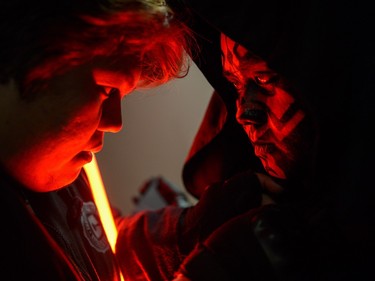 A member of Malaysia's Star Wars Fan Club, left, adjusts the outfit of his colleague, dressed as Darth Maul, before watching Star Wars: The Force Awakens at a cinema in Subang, outside Kuala Lumpur on December 17, 2015.