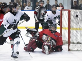 Goalie Megan Kirkland of the Red Deer Sutter Fund Chiefs keeps her eye on the puck as Hailey Tyndall, left, of the Saskatoon Stars tries to score during first period action at the Mac's AAA midget hockey tournament on Thursday, December 29, 2011 in Calgary. For the second time in the last three years there will be no Saskatoon teams at the Mac's Midget AAA Hockey Tournament.