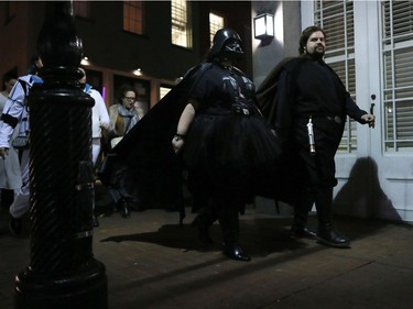 Members of the Intergalactic Krewe of Chewbacchus parade through the French Quarter, Thursday, Dec. 17, 2015, in New Orleans. The group, a Mardi Gras parade club, is celebrating the premiere of the latest "Star Wars" movie with costumes, a brass band and a parade through the French Quarter.