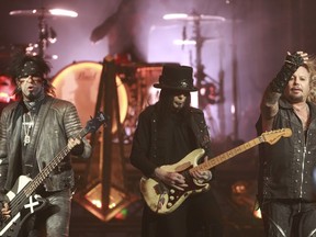 Hard-rock veterans Mötley Crüe are on their farewell tour. Lead singer Vince Neil, right performs with bass guitarist Nikki Sixx, left and Mick Mars, middle at the Bell Centre in Montreal, Monday August 24, 2015.  (Marie-France Coallier / MONTREAL GAZETTE)
