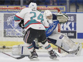 Kelowna Rockets forward Tyson Baillie gets a shot past Saskatoon Blades goalie Evan Smith during first-period WHL action on Saturday.