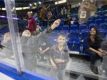 Fans throw teddy bears onto the ice after the Saskatoon Blades score their first goal against the Kelowna Rockets during first period WHL action, December 19, 2015.