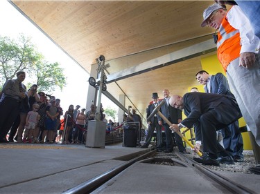 The Potash Corp Kinsmen Playland Grand Opening had mayor Don Atchison pounding the final rail road spike with many dignitaries to officially open the wonderland, August 12, 2015.