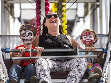 It was kids' day at the Exhibition but it wasn't all about the kids, August 5, 2015. Jillian Grasby was full of laughter on the Kidsville Ferris Wheel with her children Finn and Harper.