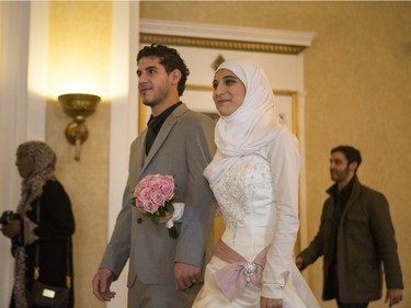 Athar Farroukh, right, and Mohamad Al-Noury walk to their wedding gathering at the Delta Bessborough on Sunday, December 6th, 2015.