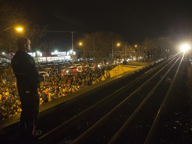 Saskatoon Police attempt to keep the railway tracks clear as a large crowd, estimated over 10 000, gathers as the CP Holiday Train arrives to make a stop at the Seventh Avenue Railway overpass in Saskatoon, December 6, 2015.