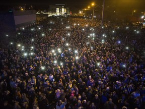 A large crowd, estimated over 10,000, gathers to watch as the CP Holiday Train makes a stop at the Seventh Avenue Railway overpass in Saskatoon, December 6, 2015.