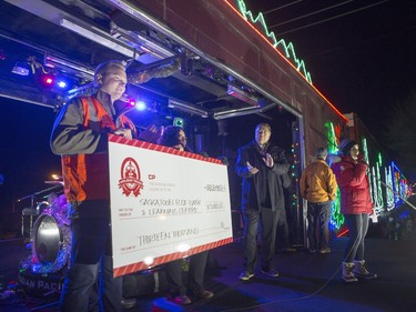 CP Rail presents Saskatoon Mayor Don Atchison and the Food Bank with a cheque during the CP Holiday Train stop at the Seventh Avenue Railway overpass in Saskatoon, December 6, 2015.