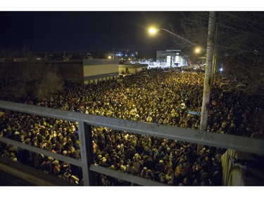 A large crowd, estimated over 10,000, gathers prior to the CP Holiday Train making a stop at the Seventh Avenue Railway overpass in Saskatoon, December 6, 2015.