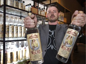 LB Distillers co-owner Cary Bowman holds two bottles of Lucky Bastard vodka. The federal trademark office deemed the name "obscene" and "scandalous."