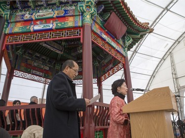 Masters of ceremonies speak during the unveiling of the new Chinese Ting artwork event in Victoria Park, December 12, 2015.
