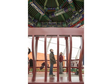 Vistors look at the roof of the Zhongshan Ting during the unveiling of the new Chinese Ting artwork event in Victoria Park, December 12, 2015.