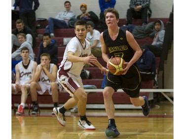 Legacy Christian Academy Eagles' James Hough moves the ball against Centennial Chargers' Jeff Erickson during the Centennial Charger Charity Classic basketball tourney at Centennial Collegiate, December 12, 2015.