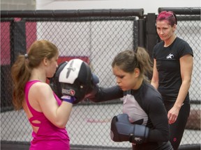 Charmaine Tweet, right, professional mixed-martial artist teaches a women's self-defence class to Alexandra Markou, centre, and Kat Duncombe at Alliance Training Center on Sunday, Dec. 13, 2015.