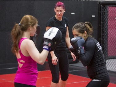 Charmaine Tweet, centre, professional mixed martial artist teaches a womenÕs self-defence class to Alexandra Markou, right, and Kat Duncombe at Alliance Training Center on Sunday, December 13th, 2015.