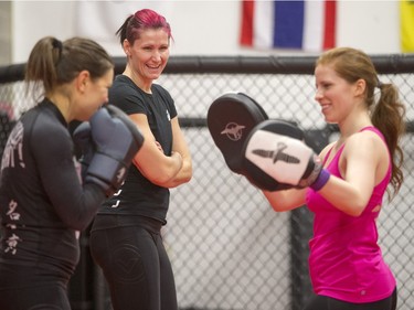 Charmaine Tweet, right, professional mixed martial artist teaches a womenÕs self-defence class to Alexandra Markou, left, and Kat Duncombe at Alliance Training Center on Sunday, December 13th, 2015.