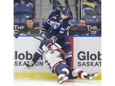 Saskatoon Blades forward Luke Gingras knocks over Regina Pats forward Lane Zablocki during second period WHL action, December 13, 2015.