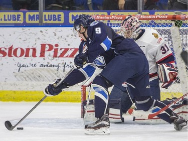 Saskatoon Blades forward Cameron Hebig attempts a shot on Regina Pats goalie Tyler Brown during second period WHL action, December 13, 2015.
