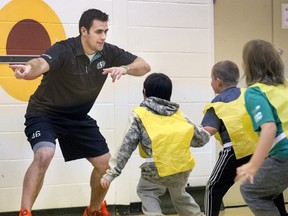 Saskatchewan Roughriders long snapper Jorgen Hus works with students at St. Edward School as part of the school's Build Our Kids' Success (BOKS) program, a free before-school program that promotes physical activity and good nutrition as part of a healthy lifestyle.