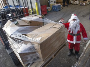 SASKATOON, SASK.; DECEMBER 18, 2015 - Rosenau Transport's decorated semi-truck and trailer pulled up to the Saskatoon Food Bank and Learning Centre and with the help of Santa for one pallet the very special delivery of about 6000 pounds of food and money were unloaded, December 18, 2015 (GORD WALDNER/Saskatoon StarPhoenix)