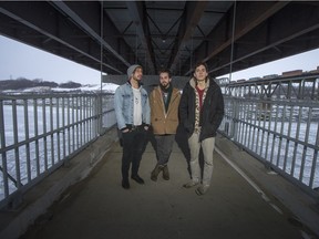 Grimsrud-Manz, left to right, Mario Lepage, and Adam Logan of the band Pontiex pose for a photograph on the pedestrian bridge of the North Commuter Parkway on Saturday, December 19th, 2015.