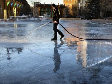 Jason Pyakutch was putting an early morning flood on the Meewasin Rink, December 3, 2015. The ice was stilling freezing in the warmer weather, but very slowly.