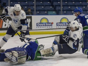 Saskatoon Blades forward No. 29 Nikita Soshnin is knocked into the Swift Current Broncos #30 goalie Landon Bow after carrying the puck to the net and with Blades No. 24 Terrell Draude on the door step finds a loose puck to score in first period WHL action at SaskTel Centre, Dec. 30, 2015.