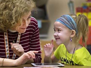 RUH Hospital and Homebound School Program educator Andra Thorstad spends time reading with seven-year-old hospital patient Lyla Williams in the hospital's fourth floor classroom, February 11,  2015.