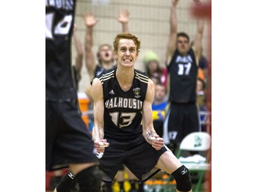 Dalhousie University Tigers #13 Connor Maessen gets excited with teammates after scoring a point during a game against the York University Lions at the PAC Centre in Saskatoon in the opening game of the CIS Men's Volleyball Championships, February 26, 2015.