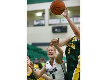 University of Saskatchewan Huskies #8 Taya Keujer battles Regina Cougars #9 Jennilea Coppola for a rebound, January 16, 2015.