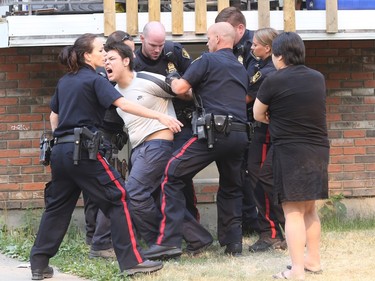 Emergency personnel were on the scene in the 500 block of Avenue H South where a distressed male removed his clothes and jumped from one house to another, July 6, 2015. Eventually, he came down on the balcony of one home and was taken into custody.