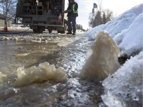 City workers prepare to defrost the valve in the pavement to shut off the water at Taylor Street and Victoria Avenue for a water main break in March.
