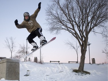 Cale Ochitwa jumps at River Landing in Saskatoon, November 27, 2015. He and his Barely crew try to find urban terrain that they can turn into snowboard parks with some shovelling and building of ramps.
