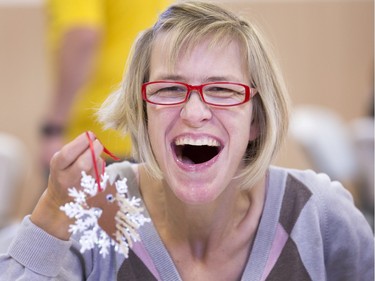 Tammy Stevens is having so much fun creating her snowflake christmas decoration, an equestrian decoration at an afternoon where Special Olympic Athletes were cutting, drawing and glueing handmade tree decorations before placing them on the tree bound for the 2015 City Hospital Foundation's Festival of Trees at the WDM, November 12, 2015.