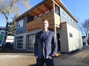 Laneway Suites owner Jeff Nattress poses in front of the garage suite he is building behind his North Park home in October. Natttress is concerned new rules for garden/garage suites approved Monday will mean only those with large homes can build them.