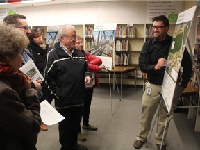 Saskatoon's special projects manager Dan Willems can be seen explaining plans for the Traffic Bridge to members of the public at an open house at the Victoria Public School library on Wednesday night. At the event, residents had a chance to ask questions and get information on both the Traffic Bridge replacement and the North Commuter Parkway Project. In the coming weeks, the site under the Traffic Bridge, which for the most part has remained idle, will become much busier as construction on the project ramps up.
