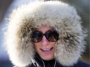 Saskatoon hit a high of 3 C on Monday, but it some people still required covering up, as Sheena Hopper demonstrated when walking her dogs on Assibioine Drive.