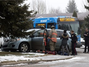 Firemen work to help a person inside a van which was in a collision with a city bus at Egbert Avenue and 104th Street earlier this month.