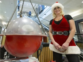 Megan Schindel is a Salvation Army kettle volunteer who dresses up as Santa and sings at Midtown Plaza.