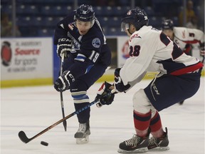 Ryan Graham of the Saskatoon Blades lets a wrist shot go in front of Brady Reagan of the Lethbridge Hurricanes  during Western Hockey League action at SaskTel Centre.