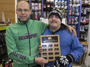 Brian Michasiw, owner of Brainsport, left,  presents Oliver Eaton with this year's  Ric Hanna Leadership Award Wednesday, December 16, 2015.