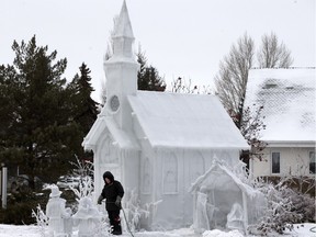 Colder temperatures has meant good news for some people around Saskatoon, such as Don Greer who is seen here applying water to an ice sculpture at the Resurrection Lutheran Church on Lenore Drive. The annual spectacle was delayed this year by warm weather.